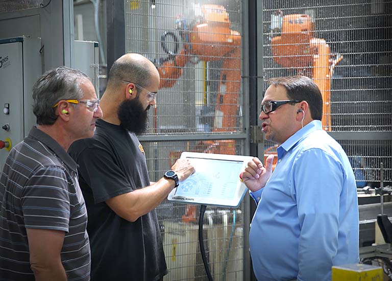 Leadership team collaborating with machine operators on the shop floor